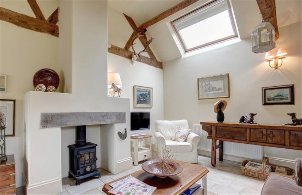 Ground floor:  Sitting area with vaulted beamed ceiling and feature fireplace with wood burning stove