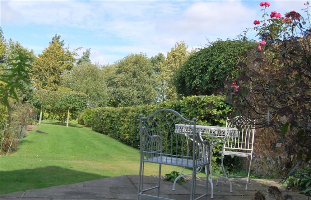 Rear garden with table with seating for two at Garden Cottage, Manor House Farm, Wellingham near Kings Lynn