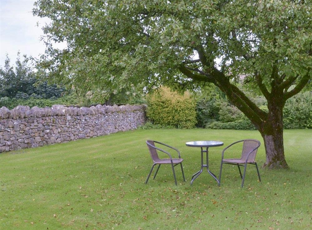 Additional seating area within large enclosed lawned garden at Garden Cottage in Newby near Penrith, Cumbria