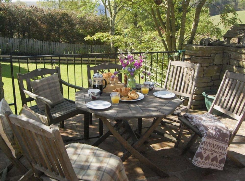 Relaxing sitting-out-area withfurniture at Garden Cottage in Pooley Bridge, Ullswater, Cumbria