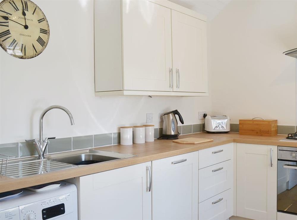 Spacious and bright, the kitchen has exposed woodwork and sloping ceilings at Garden Cottage in Ugborough, near Ivybridge, Devon