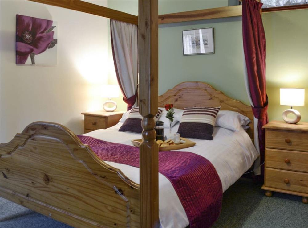 Comfortable four poster bedroom at Garden Cottage in Wheddon Cross, Exmoor, Somerset