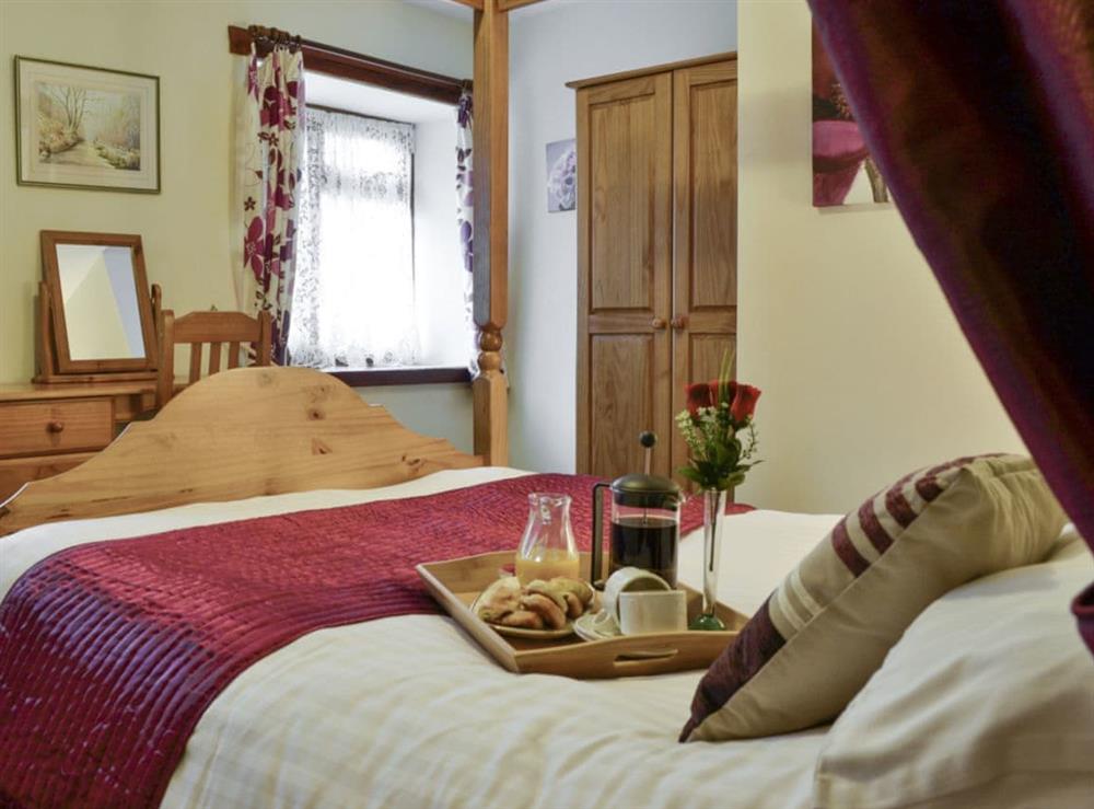 Spacious four poster bedroom at Garden Cottage in Wheddon Cross, Exmoor, Somerset