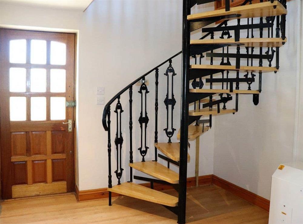 spiral staircase from upper living areas to bedroom level at Garden Cottage in Wroxall, near Ventnor, Isle of Wight