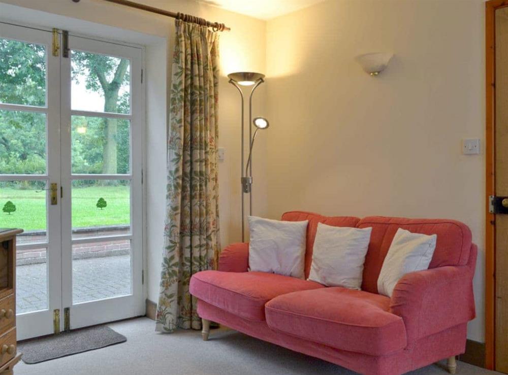 Stylish living room with French doors to patio at Garden Farm Cottage in Ilam, Nr Ashbourne, Derbyshire., Staffordshire