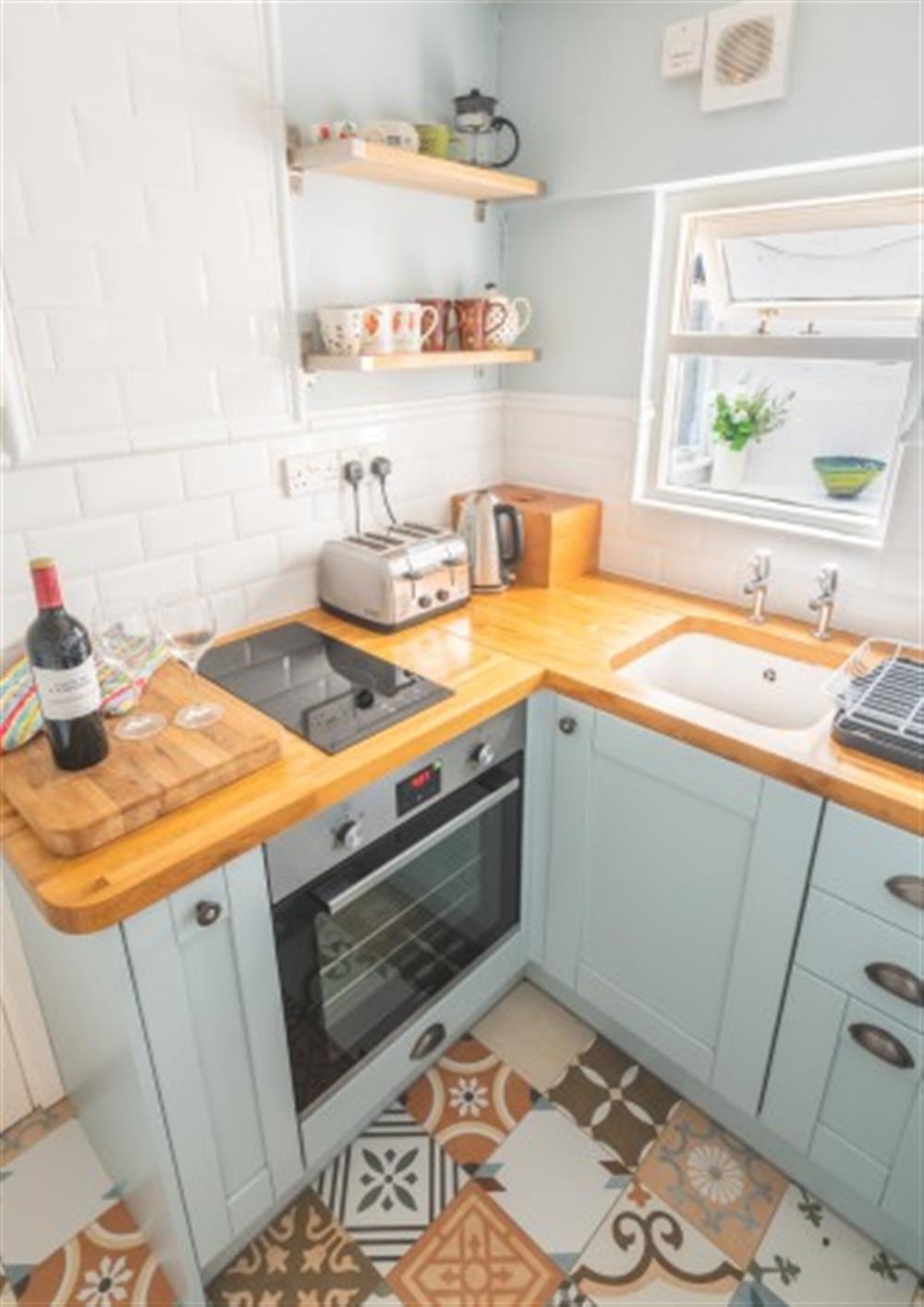 Compact cottage style kitchen at Garden Flat in Lyme Regis