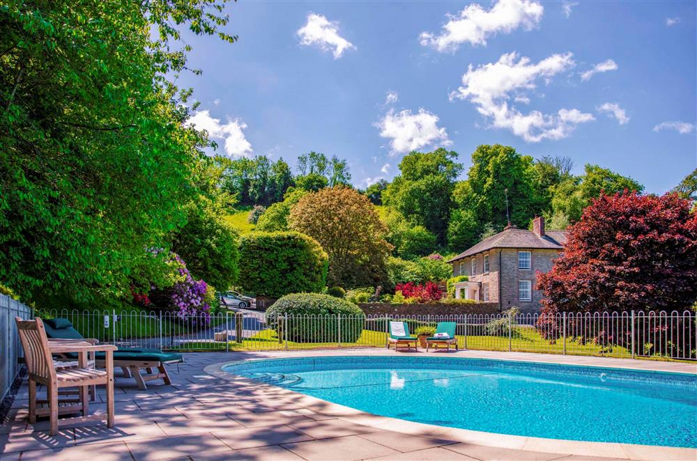 Seek sun and shade at the relaxing shared outdoor pool at Garden House, Dartmouth