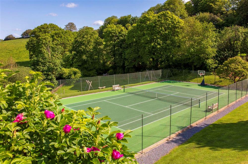 The full-size tennis court, available for guests to use at Garden House, Dartmouth