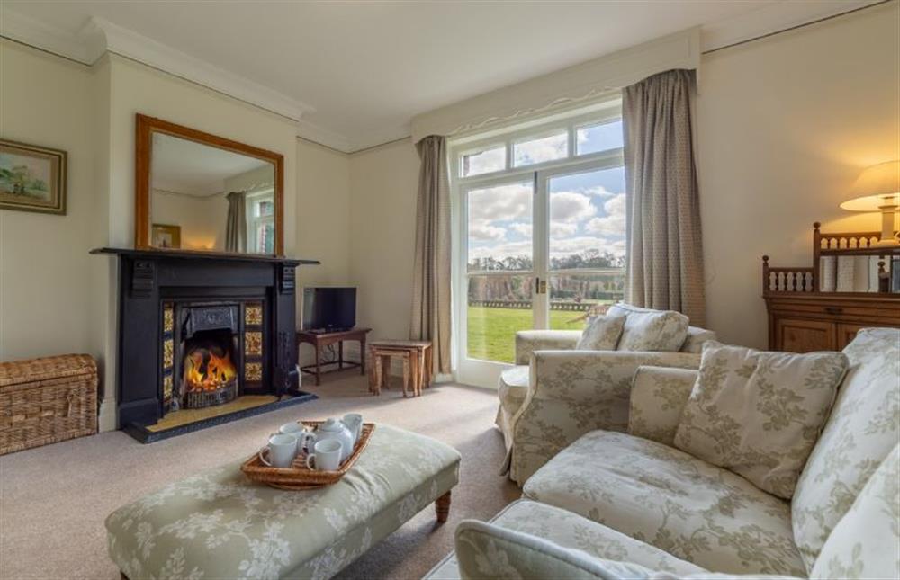 Ground floor: Spacious and bright sitting room with open fire at Garden House, Sandringham