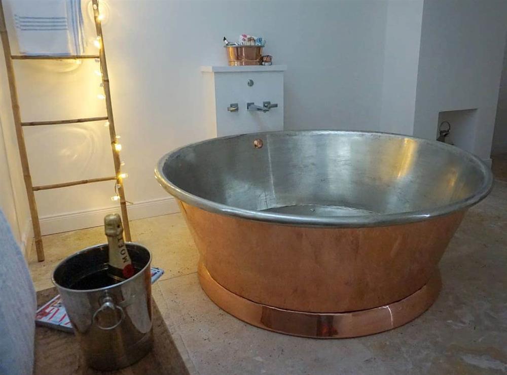 Luxurious bathroom with circular, copper bath (photo 2) at Garden House in Thimbleby, near Northallerton, North Yorkshire