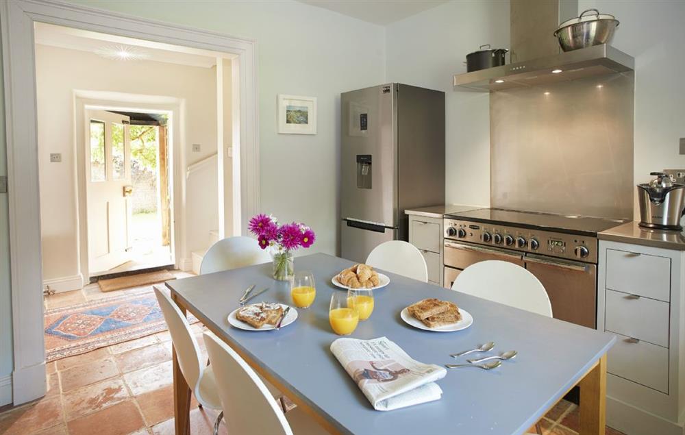Kitchen with dining table seating six guests at Garden House, Wolterton