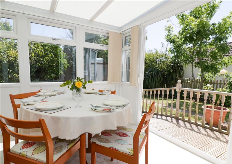 Conservatory with a dining table at Garden View, Quintrell Downs near Newquay, Cornwall