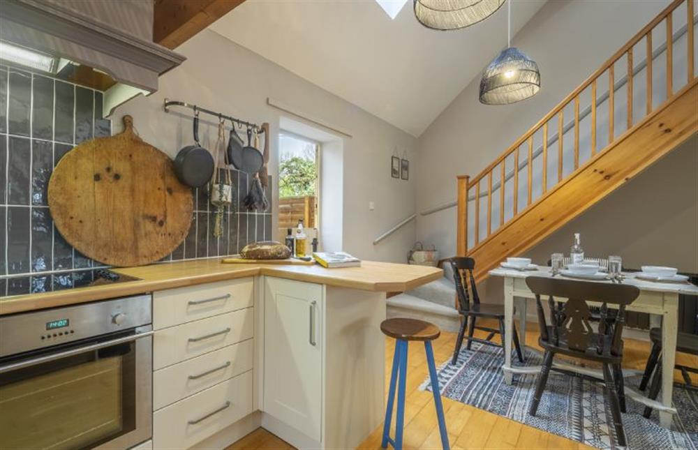 Ground floor: Kitchen looking to dining area and stairs to the first floor at Garden Wall Cottage, Great Snoring near Fakenham