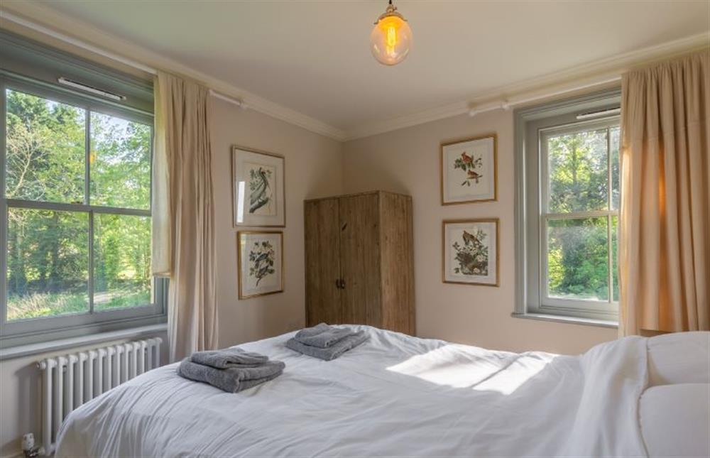 First floor: Bedroom four with wardrobe and dual aspect windows at Gardeners Cottage, Fring near Kings Lynn