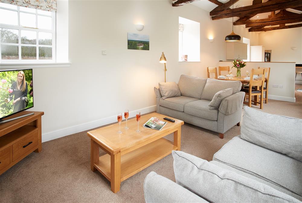 The open-plan living style connects the sitting room, dining area and kitchen at Gardeners Cottage, Netherby Hall, Longtown