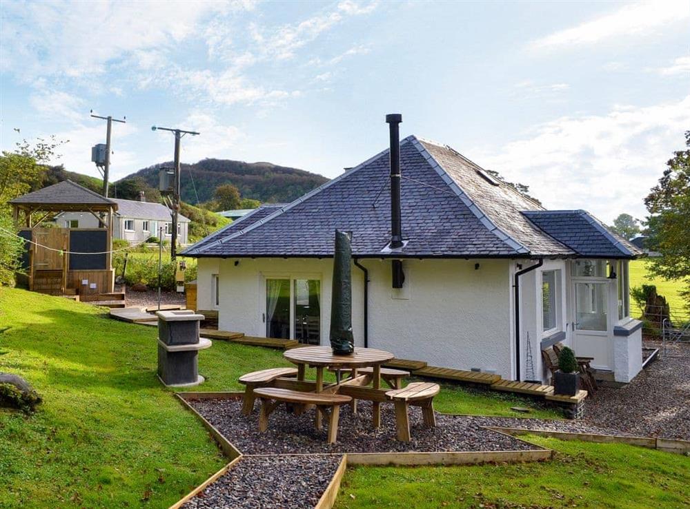 Enclosed garden with terraces and garden furniture at Gardeners Cottage in Onich, near Fort William, Inverness-Shire