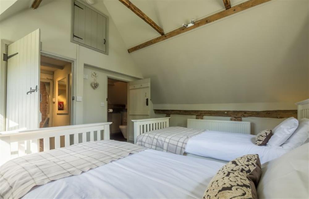 First floor:  Twin bedroom with door to en suite cloakroom at Gardeners Cottage, Thornham Magna near Eye