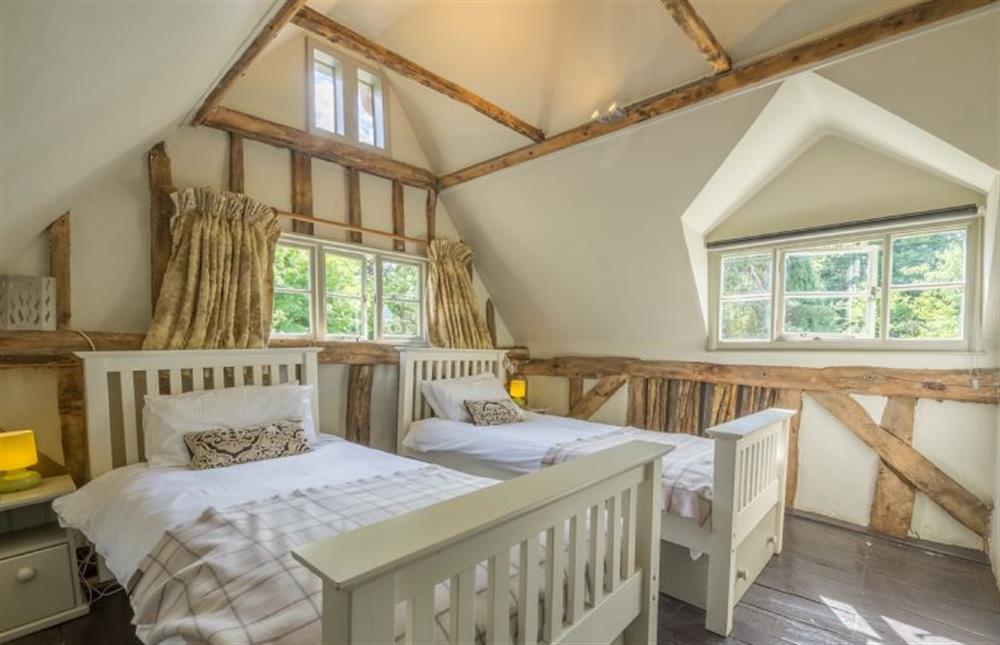 First floor:  Twin bedroom with feature window at Gardeners Cottage, Thornham Magna near Eye