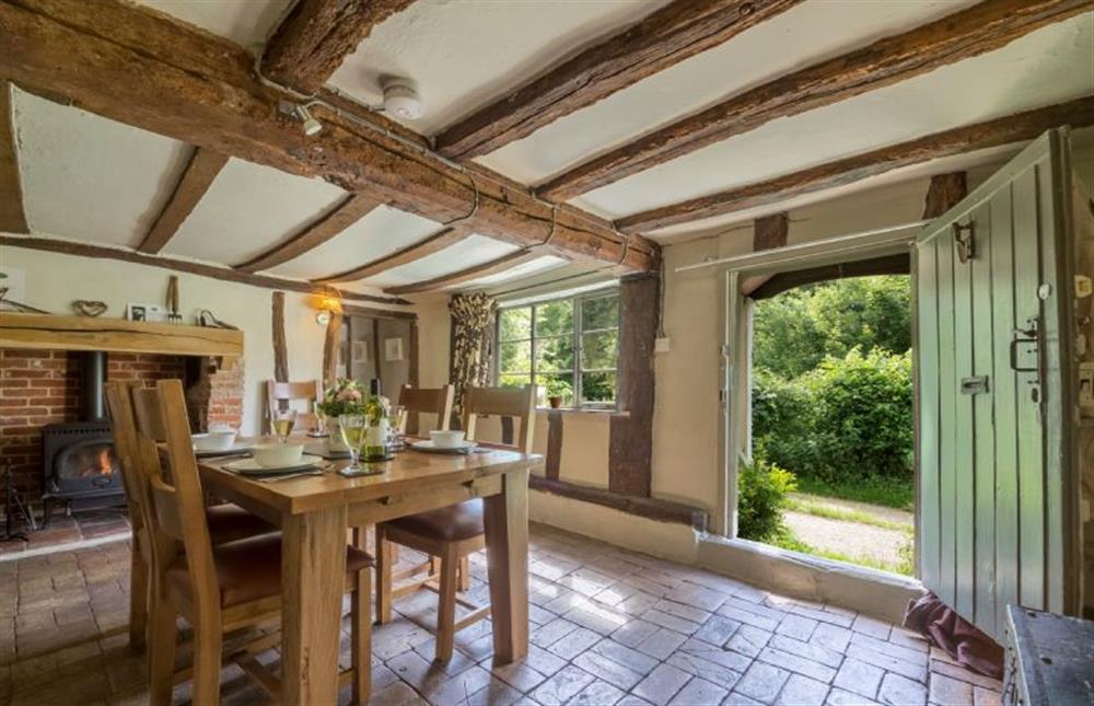 Ground floor: Dining table seating four and door to outside at Gardeners Cottage, Thornham Magna near Eye