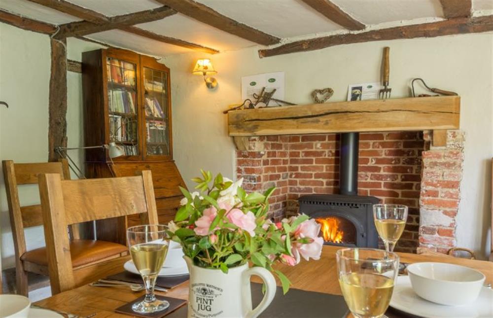 Ground floor: Dining table seating four with wood burning stove at Gardeners Cottage, Thornham Magna near Eye