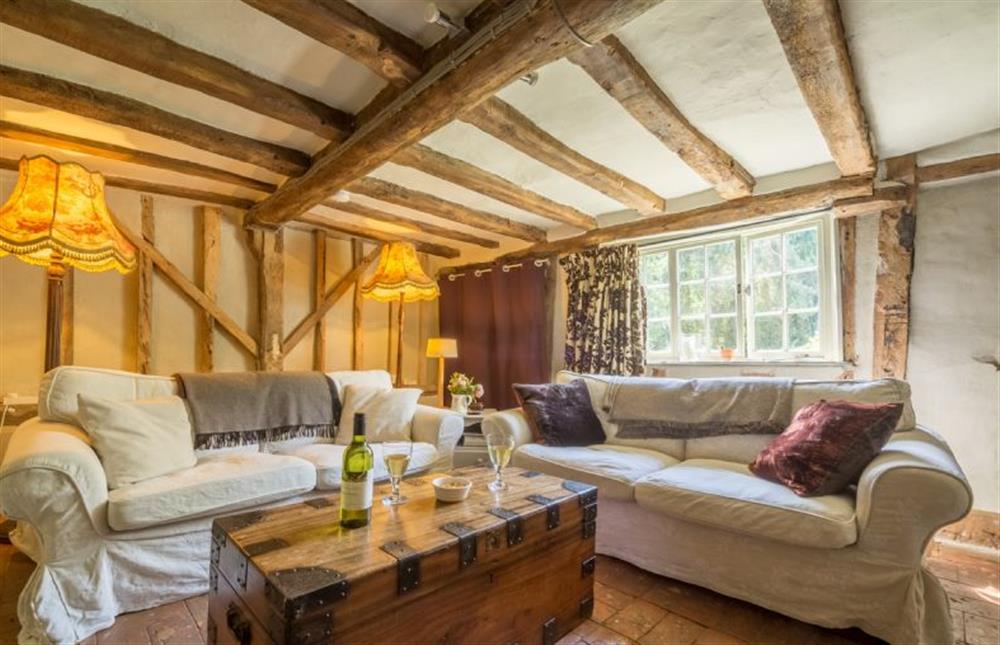 Ground floor: Seating area with comfy sofas at Gardeners Cottage, Thornham Magna near Eye
