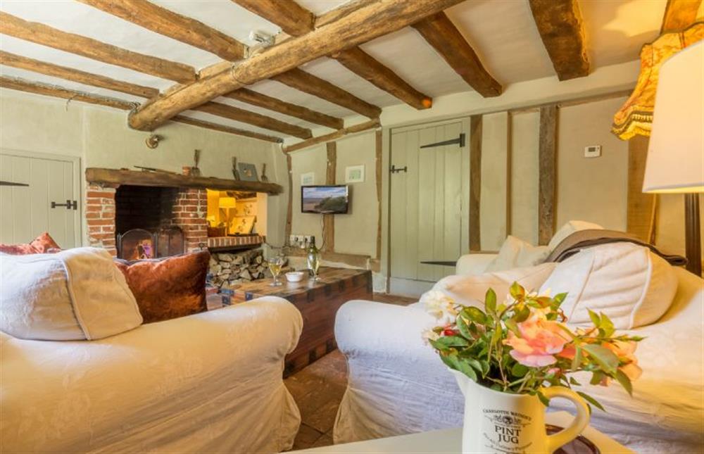 Ground floor: Seating area with feature beamed ceiling and open fire  at Gardeners Cottage, Thornham Magna near Eye