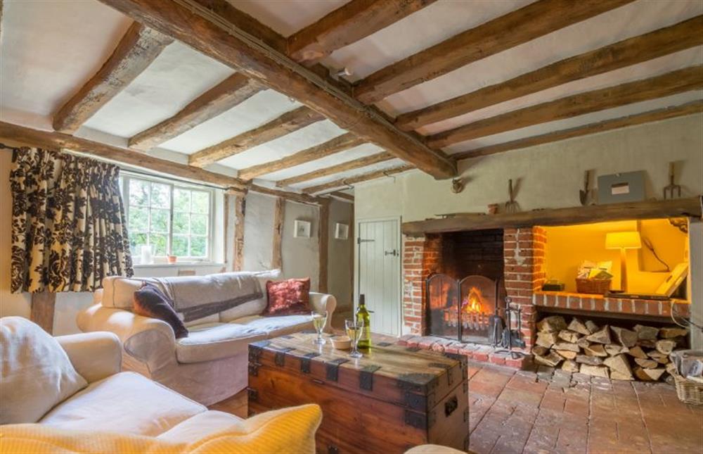 Ground floor: Seating area with large open fire for cosy nights in at Gardeners Cottage, Thornham Magna near Eye