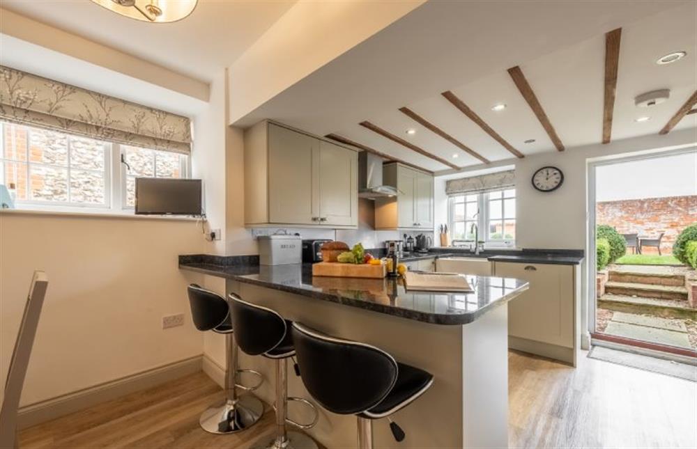 Open plan kitchen with a peninsular and seating for three at Gardeners Cottage, Thornham near Hunstanton