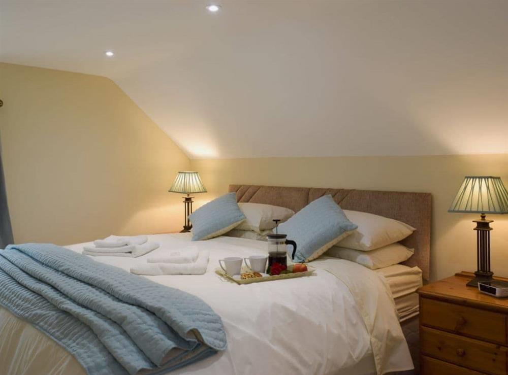 Bedroom with zip and link super kingsize bed at Gardeners Lodge in near Pembroke, Dyfed