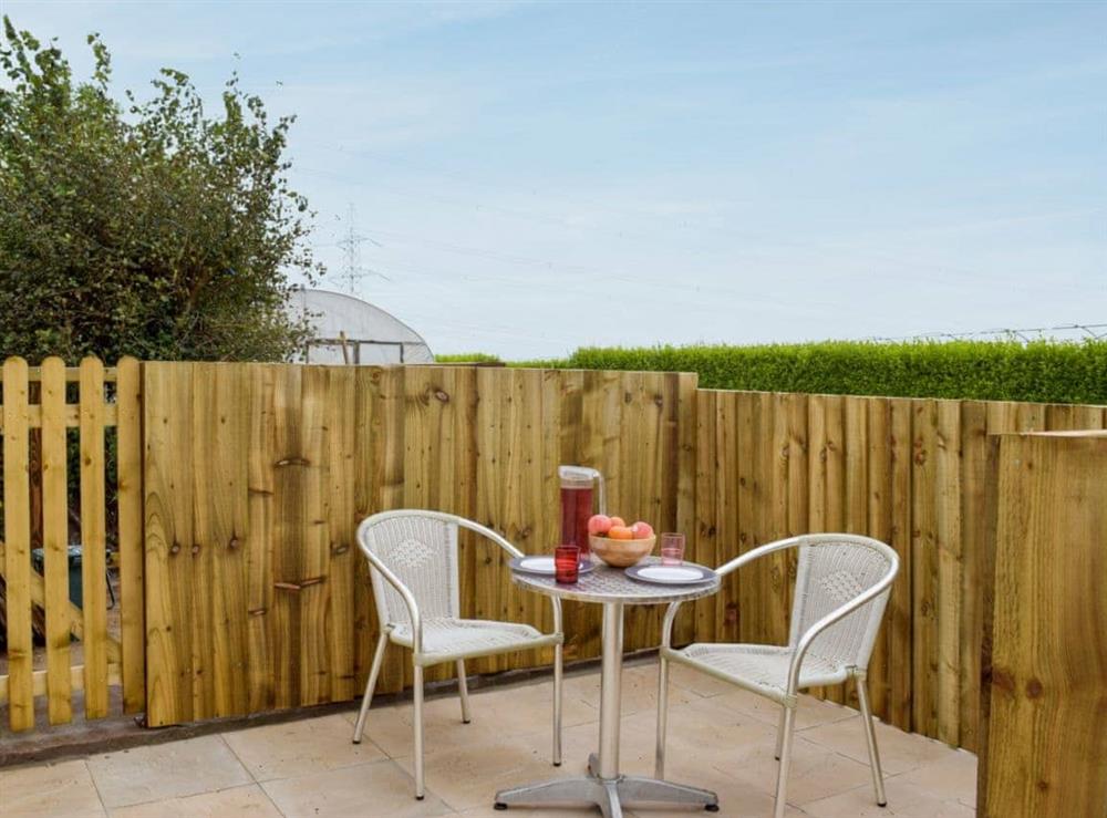 Small enclosed courtyard with patio, garden furniture and BBQ at Gardeners Lodge in near Pembroke, Dyfed