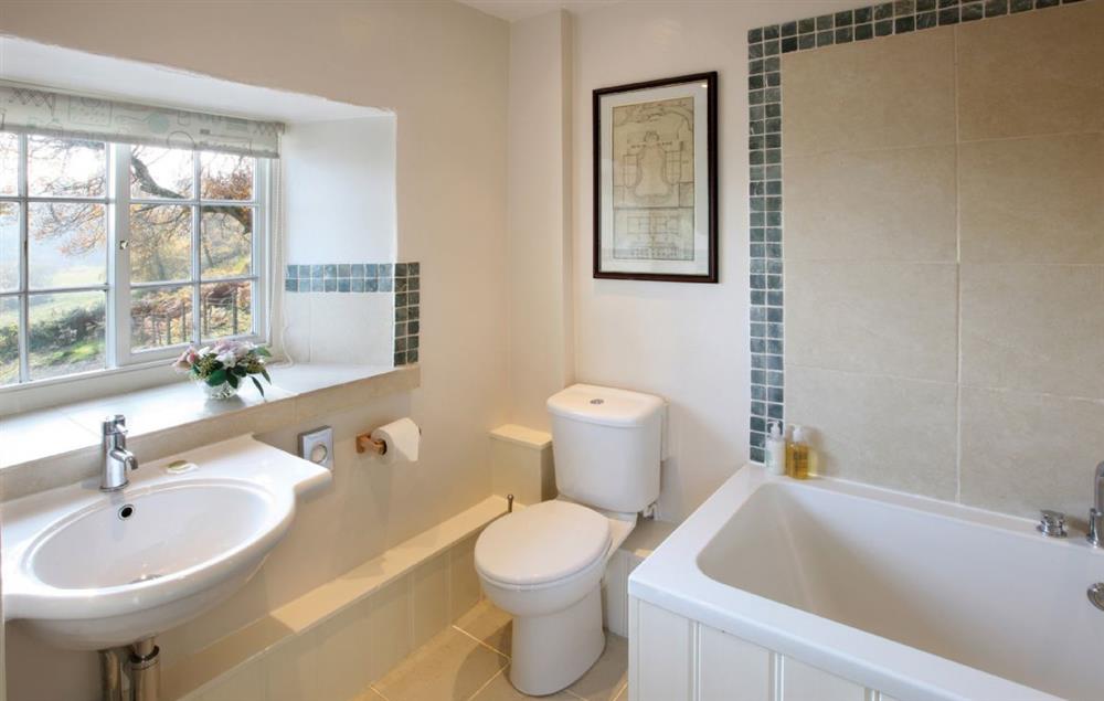 En-suite bathroom with shower over the bath at Garth Iwrch, Bodnant Estate