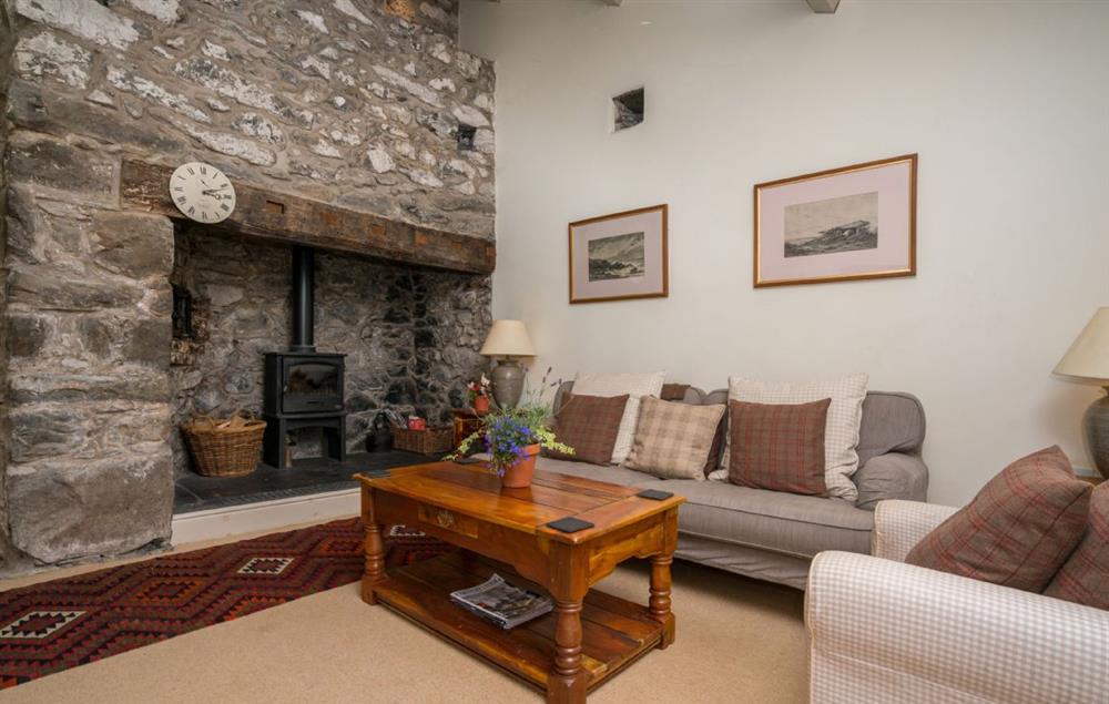 Enjoy a warming fire by the wood burning stove in the sitting room at Garth Iwrch, Bodnant Estate