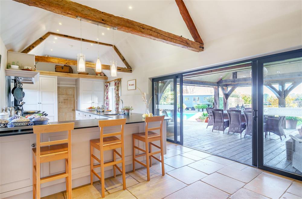 The breakfast bar with views of the garden and swimming pool at Gate Street Farm House, Bramley, Guildford
