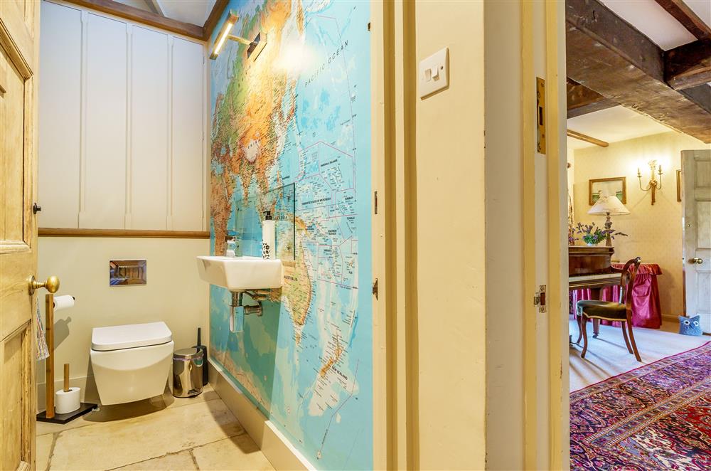The ground floor cloak room, with unique map wallpaper at Gate Street Farm House, Bramley, Guildford
