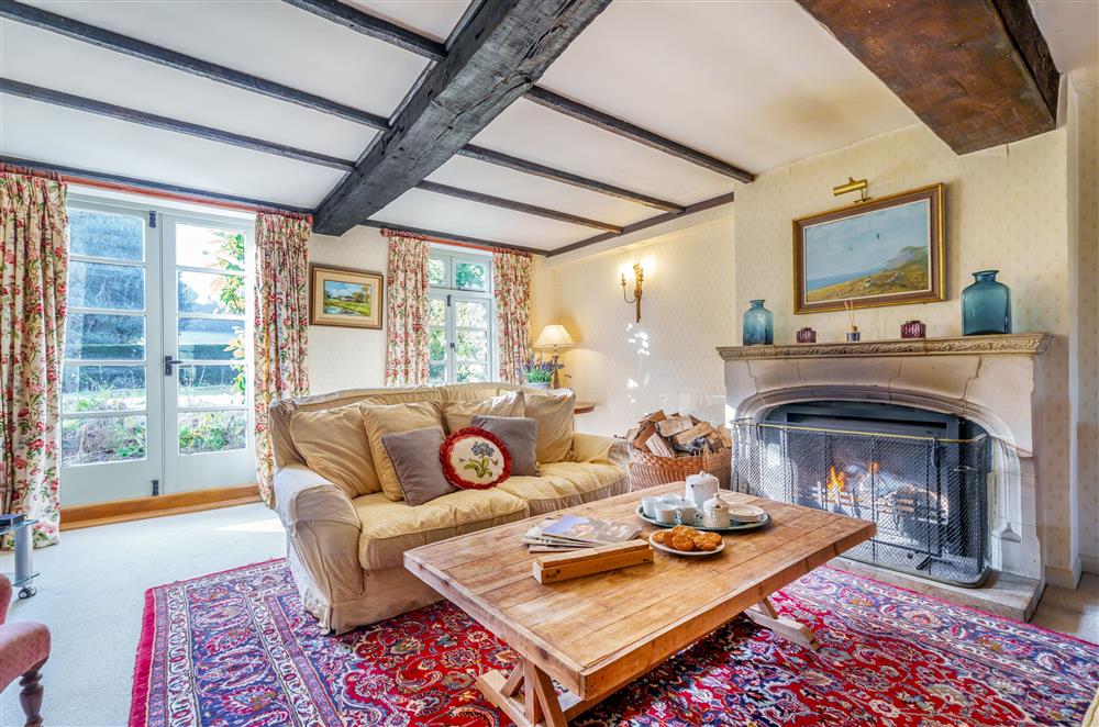 The sitting room, with stunning beams and french doors