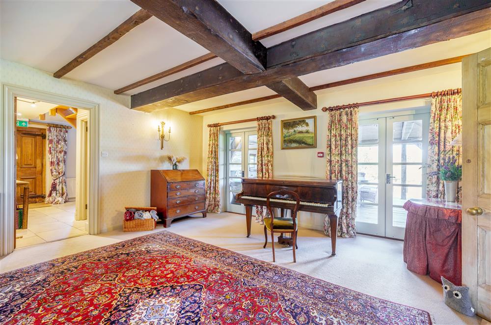 Traditional furnishings and a piano add character through the sitting room