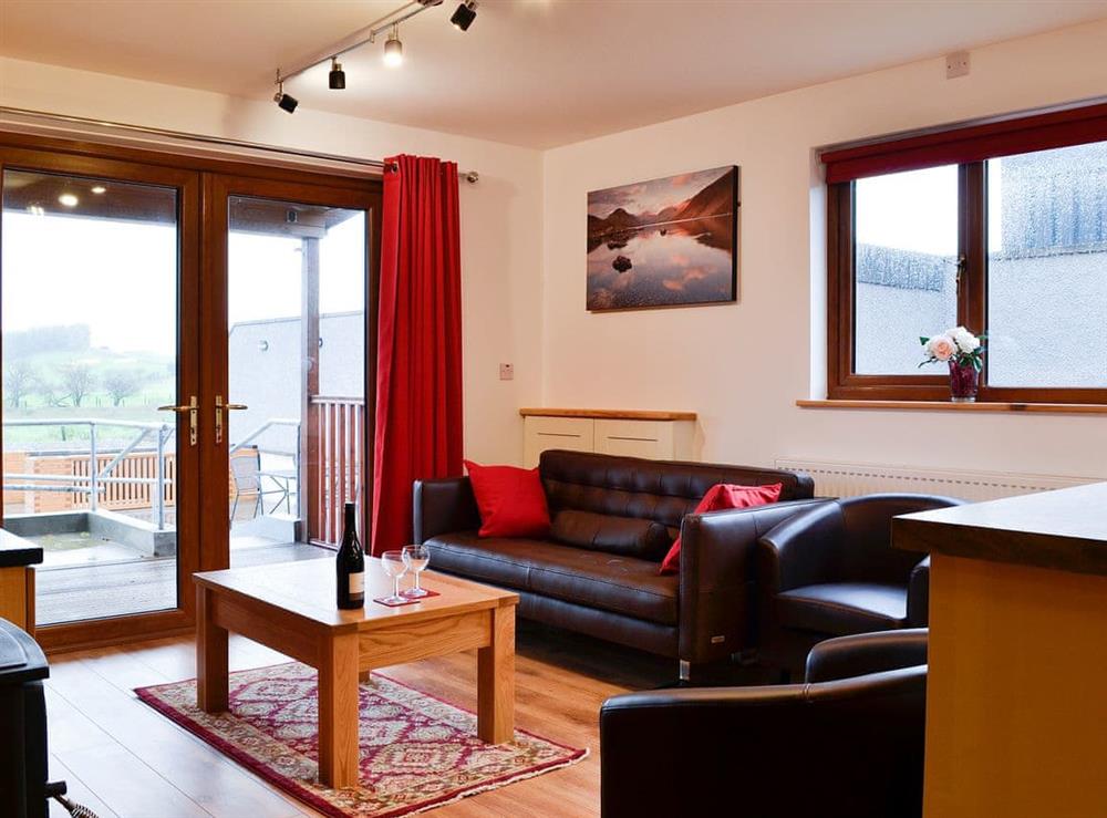 Lovely living area with patio doors to the terrace at Knock Murton Lodge, 