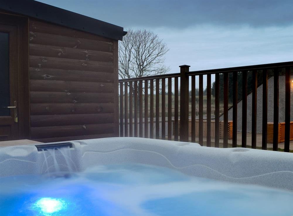 Relaxing hot tub at dusk at Knock Murton Lodge, 