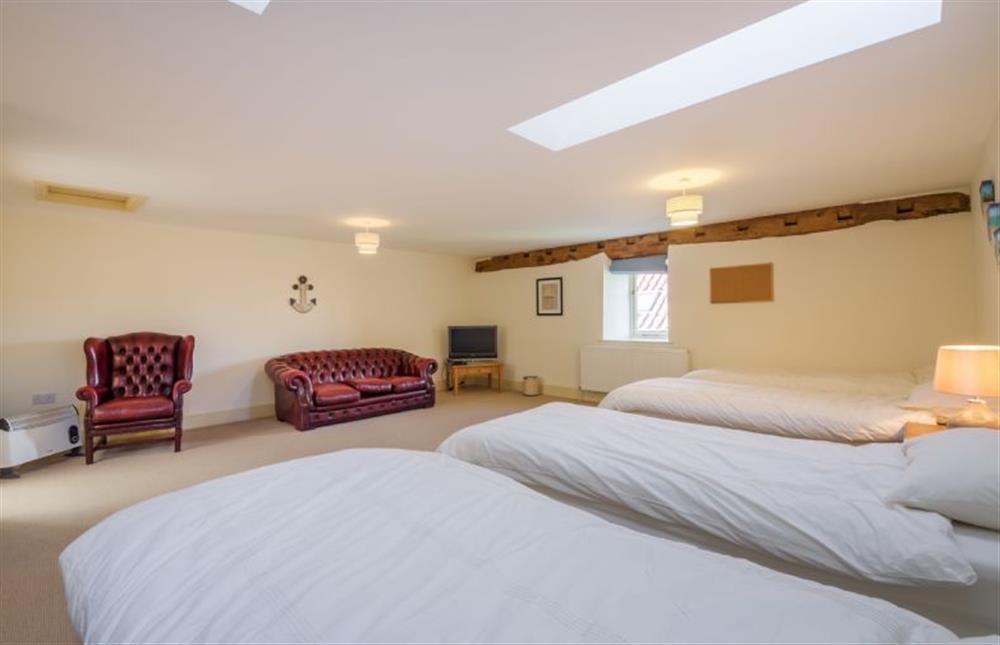 First floor: Family bedroom has comfy seating and en-suite bathroom at Geddings Farm Barn, Ringstead near Hunstanton