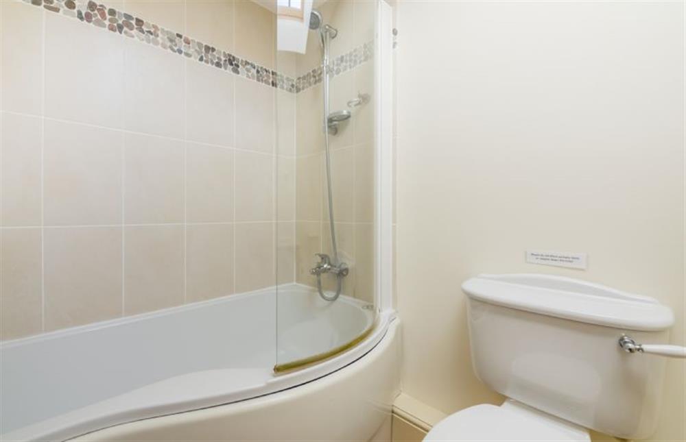First floor: Family en-suite bathroom, bath with shower over  at Geddings Farm Barn, Ringstead near Hunstanton
