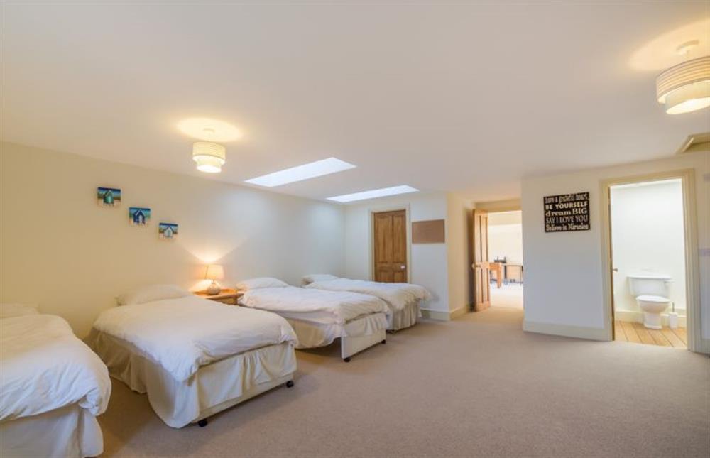 First floor: Large Family bedroom with four single beds and en-suite bathroom at Geddings Farm Barn, Ringstead near Hunstanton