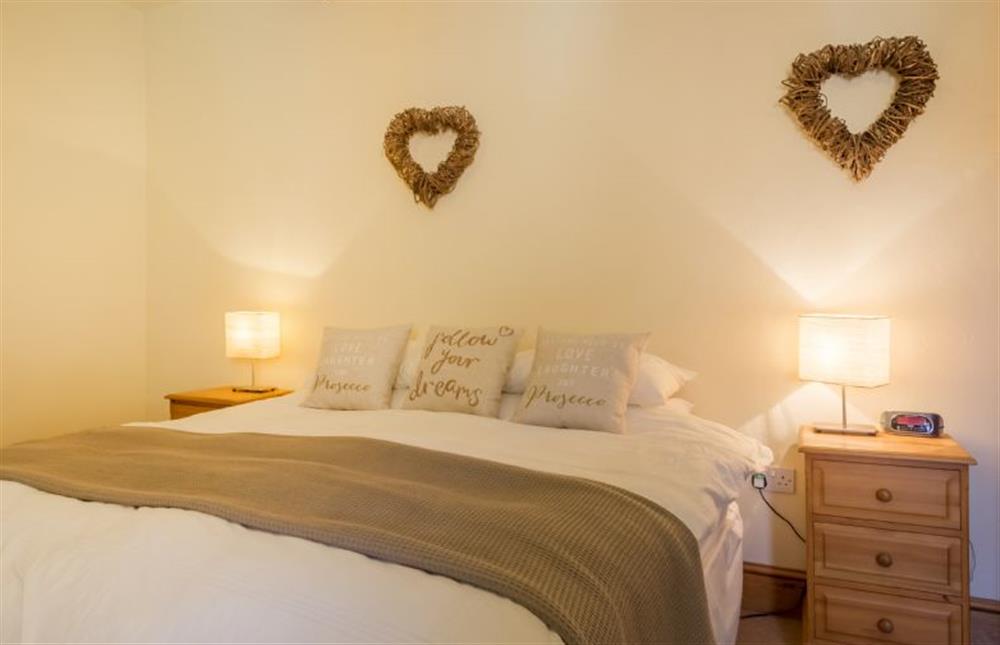 Ground floor: Bedroom two with super king-size bed at Geddings Farm Barn, Ringstead near Hunstanton