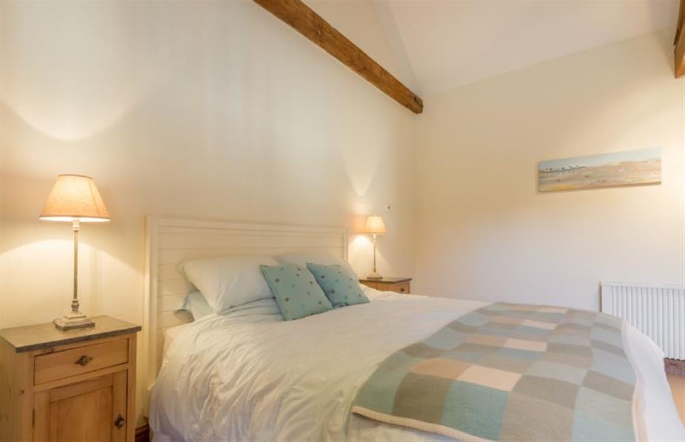 Ground floor: Master bedroom with king-size bed at Geddings Farm Barn, Ringstead near Hunstanton