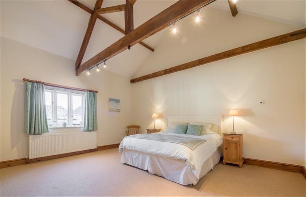Ground floor: Vaulted Master bedroom with king-size bed at Geddings Farm Barn, Ringstead near Hunstanton