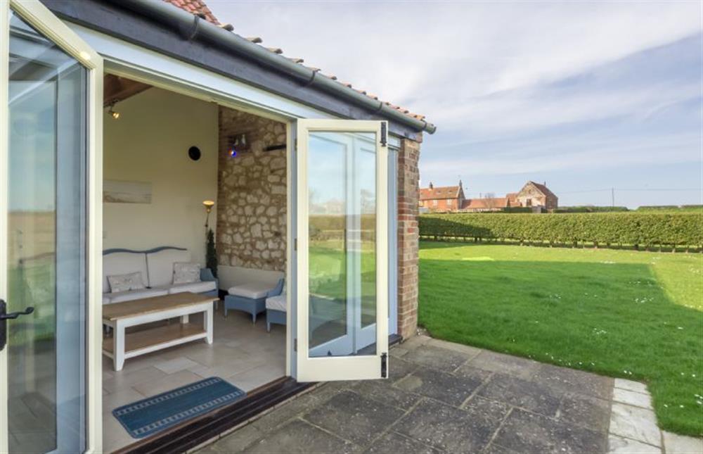 The Garden room opening out into the sizeable garden  at Geddings Farm Barn, Ringstead near Hunstanton