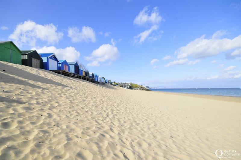 The long sandy beach at Abersoch with its beach huts is a great place to spend the day at Gelli Gron 4 bed, Criccieth