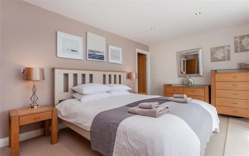 Bedroom 1 with super king size bed, estuary views and access to balcony at Genoa in Salcombe