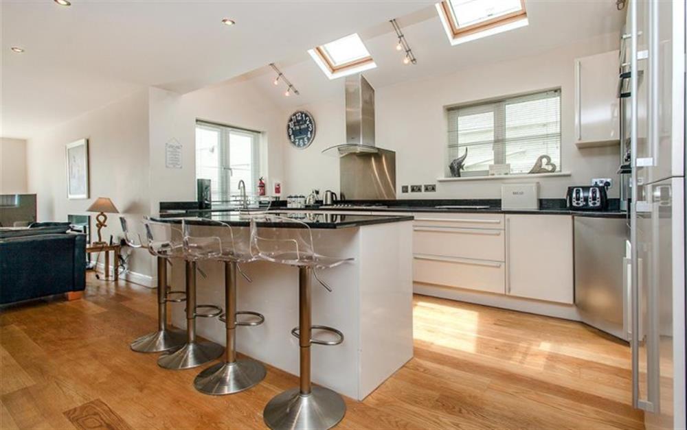 The well equipped modern kitchen with island unit and granite work surfaces at Genoa in Salcombe