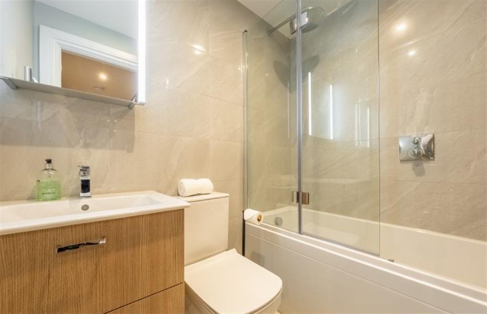 Bathroom with bath with shower over at George House, Docking near Kings Lynn