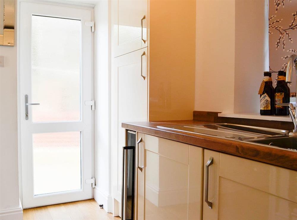 Kitchen with access to the outdoor area at Ghillie Cottage in Cockermouth, Cumbria
